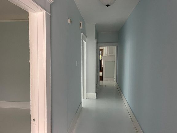 Front door down hallway with bedroom 1 on left