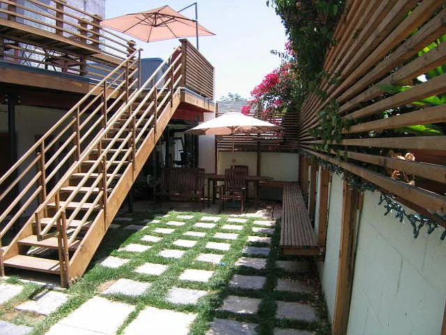 Community Courtyard picnic table and sunbrella at rear corner of Courtyard