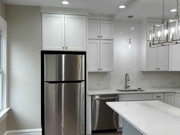 Stainless steel appliances. Large fridge with ice maker.