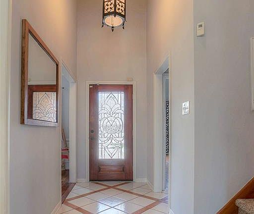 This is the front entrance taken from the Living Area. if your looking at the door the room to the left is the Classroom/ Dining Room. The hallway to the right leads to the 1/2 guest bath and Master Bedroom ensuite.