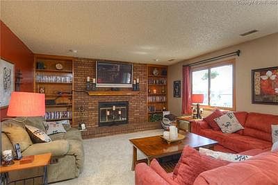 The comfortable family room features a warm fireplace, built in shelves, and acc