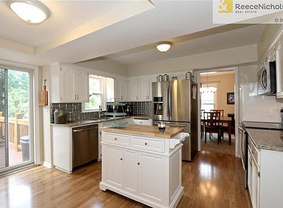 Beautiful updated Kitchen with SS Appliances, Granite Counters, Center Island, and Sliding Door to the Deck!