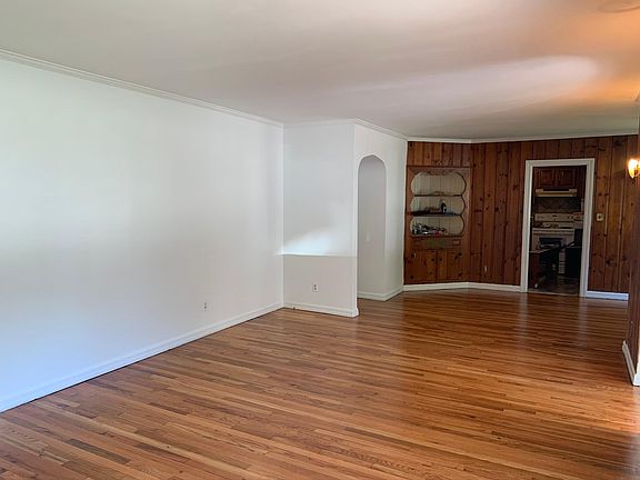 View from fireplace wall to kitchen and dining room. Built-in corner cabinet.