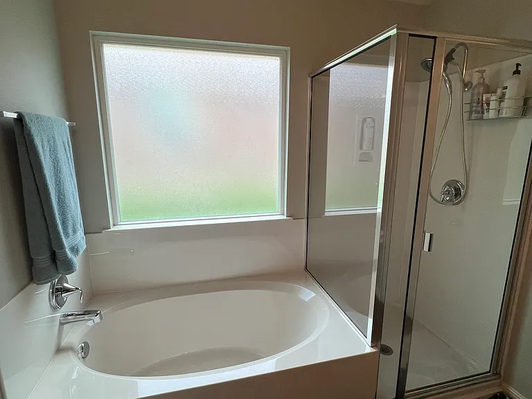 En suite bedroom has a shower and a bath