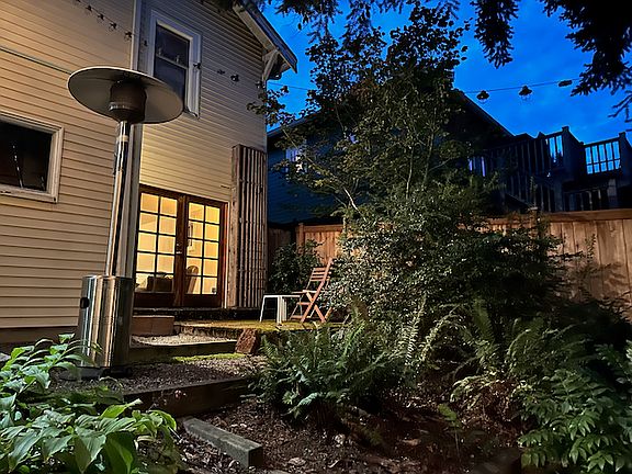 Rear of 1926 Craftsman home facing private patio and French door entrance.