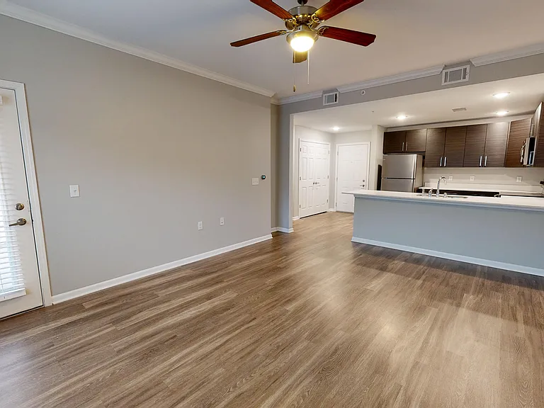 The kitchen flows into the living room with access to a private patio or balcony. The kitchen flows into the living room with access to a private patio or balcony.