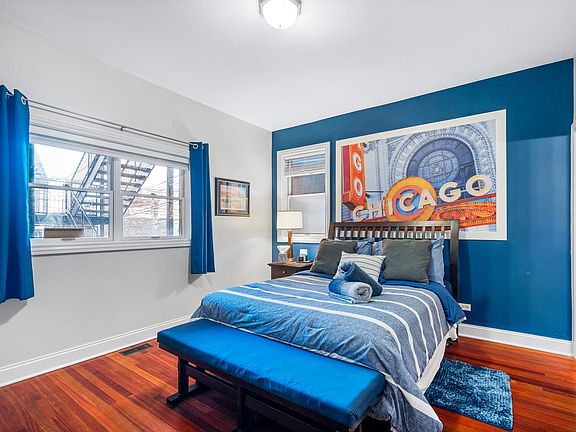 The primary bedroom features a queen bed with an ensuite bathroom. Comfortable accommodations for your visit to Chicago. Within a 10-minute walk to the CTA Addison Red line station.