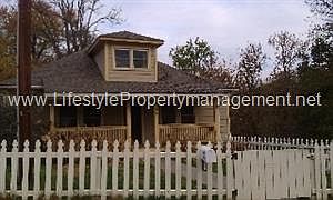 Storybook Covered Front Porch and White Pickett Fence