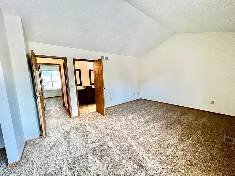 Main bedroom with private bathroom entry.
