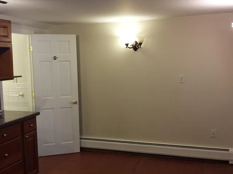 Kitchen from Livingroom entrance showing bathroom entrance