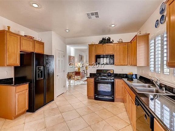 Kitchen with upgraded tile, cabinets, Granite Countertops, Appliances and shutters.