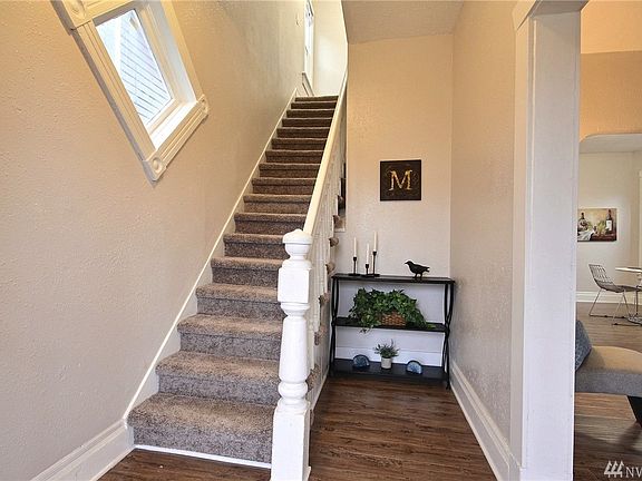flowing plan to dining room, main level bedroom and kitchen