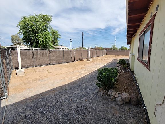 Fenced backyard with a clothing line