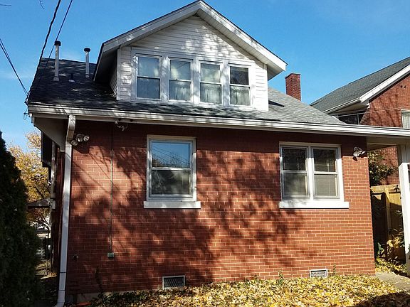 This is the rear view of the house. The window on the left is the master bedroom. Window on the right is the dinette.
