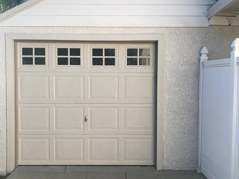 Extra deep single car garage with plenty of windows, long work bench, small storage room and side entry door as well.