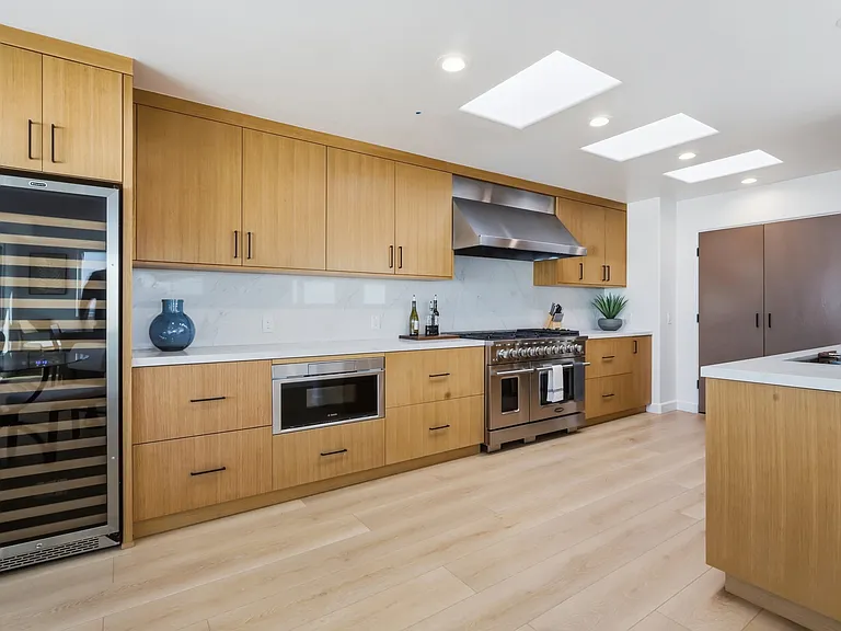 At the top of the third floor you will find a chef's kitchen with walk-in pantry, breakfast nook, 8-sit dining table, and rooftop patio with direct stair access to the street