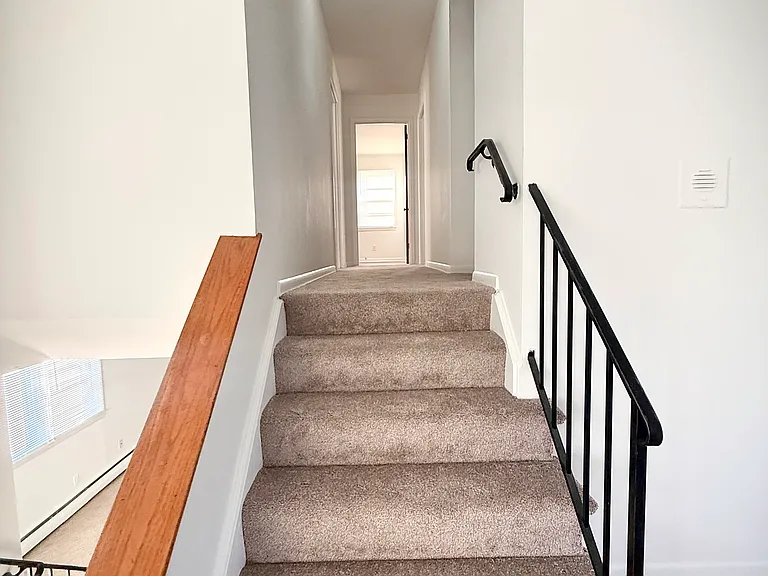 Steps and corridor to bedrooms and 2 baths