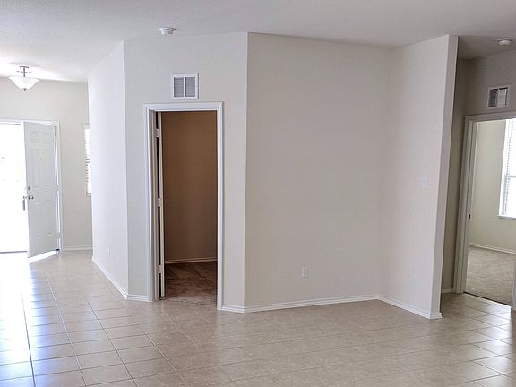 Main door is on the left and once you enter there is small coats closet on the left and entry to garage. Both doors are hidden in this picture. The door that is open in the middle is Office Room and the door open on far right is Bedroom 1 (Guest/Kids)