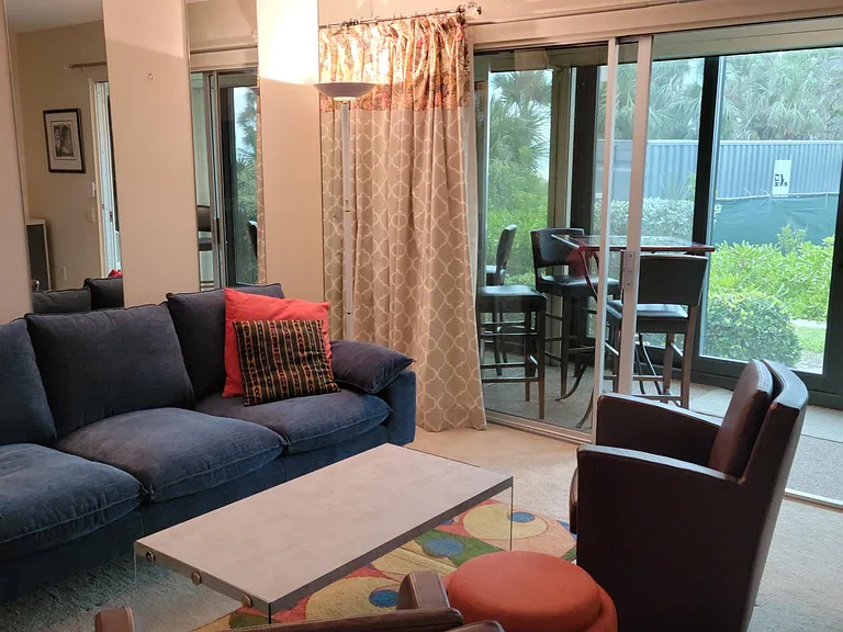 Living room with 4 chair bistro table on the lanai.
