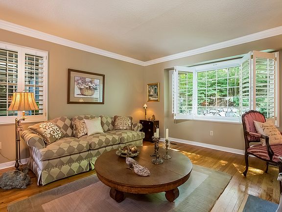 Living Room Features Crown Molding and Plantation Shutters