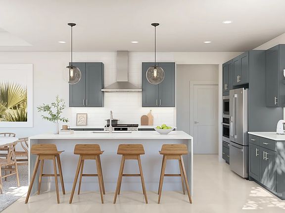 Kitchen with waterfall island and pendant lighting