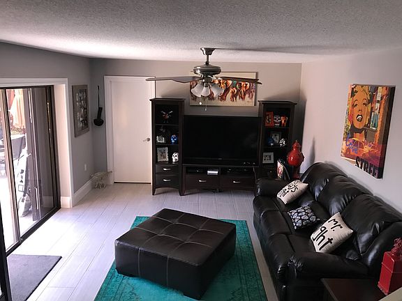Great room with sliders to private fenced patio