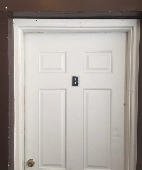 Upstairs front door. Your apartment is on the left when you get to the top of steps. Only one other apartment upstairs