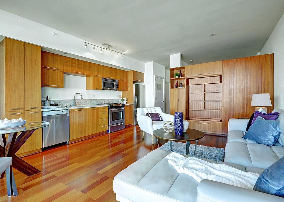 Living/Dining area, built-in book shelves and tv center.