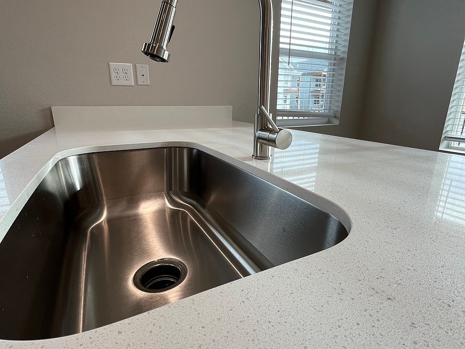 Over-sized sink with modern fixtures and solid surface countertop.