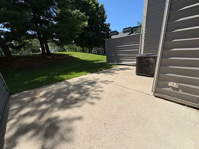 private screened rear patio (and central air conditioning unit)