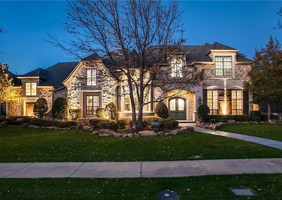 Stunning French Country Custom estate in gated Starwood.  Stone and brick facade mixed with professional landscape and lighting package create the perfect exterior ambiance.