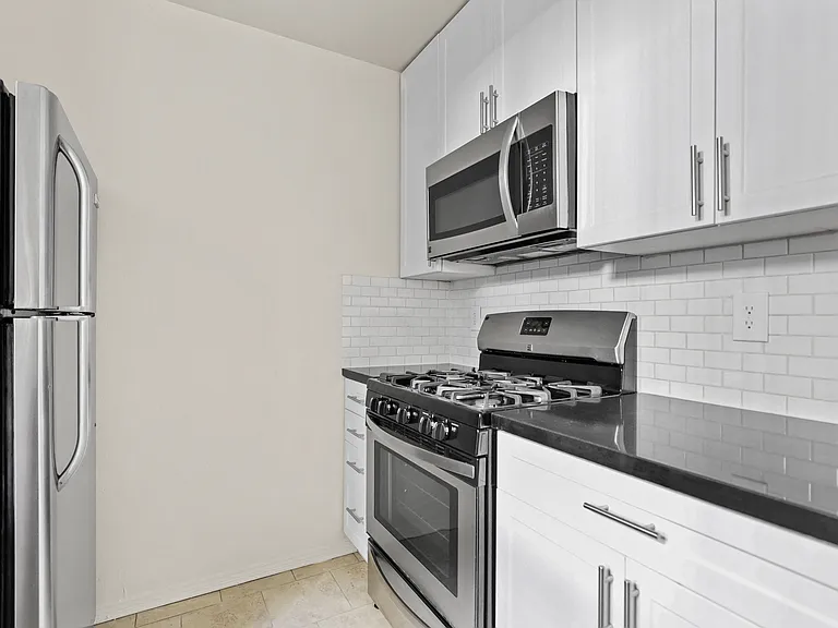 Kitchen with Stainless-Steel Refrigerator, Stove, and Microwave Oven
