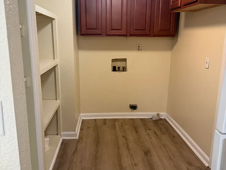 LAUNDRY ROOM WITH WASHER & DRYER HOOK-UP CABINETS FOR STORAGE SPACE
