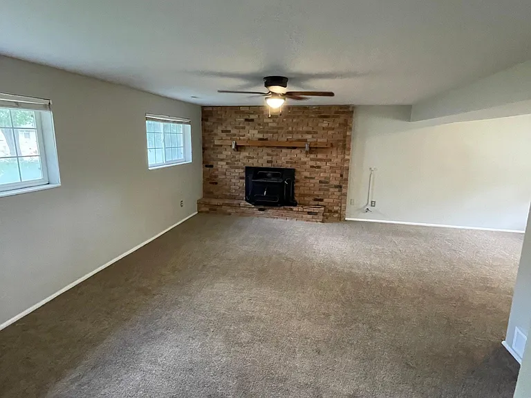 lower living room with wood burning fireplace