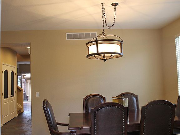 Large formal dining room with designer lighting