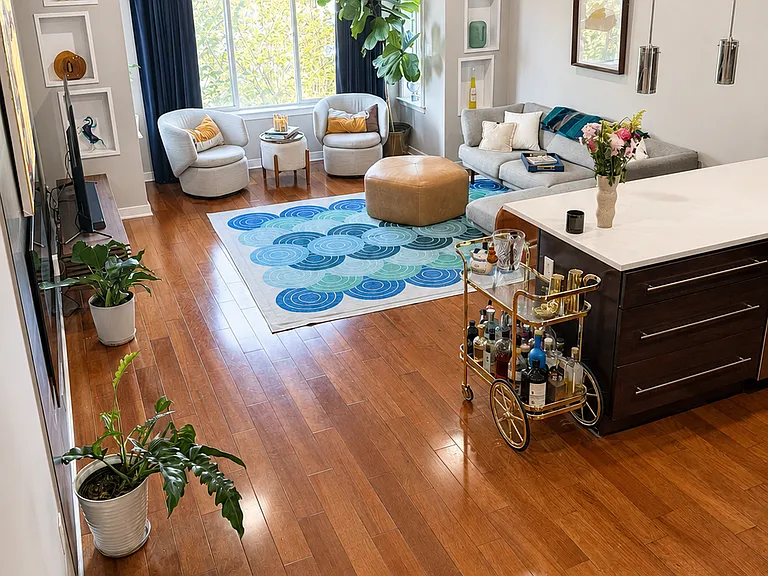 Open living area with hardwood floors and abundant natural light