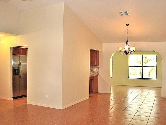 Looking from the front of home towards dining area with the family room beyond the dining area