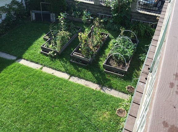View from deck overlooking large yard and garden