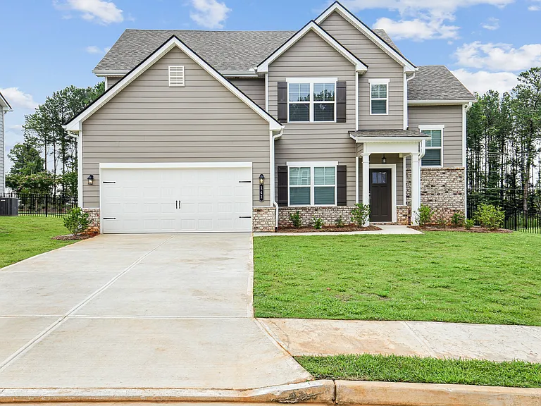 Exterior of the Oakmont, two story home with a private driveway and attached garage.