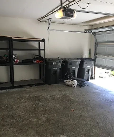 two car garage with shelving and electric garage door opener