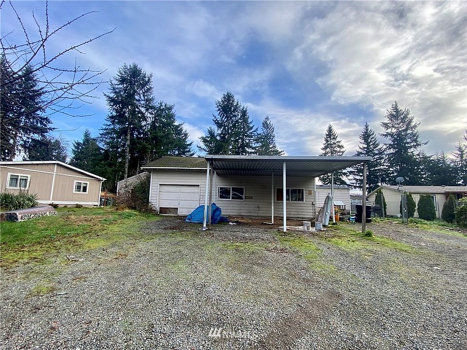 Detached garage in front.  Manufactured home is behind the garage.  