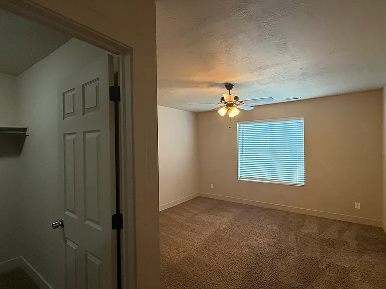 Master bedroom showing door to walk-in closet