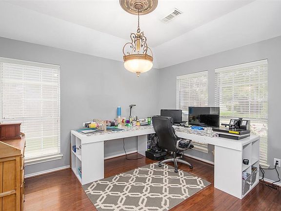 This is the Formal Dining Room now being used as a Craft Room. Imagine your Dining Room furniture here! The home has just been professionally painted in a lovely calming grey tone and is a nice contrast to the Bamboo Wood flooring.