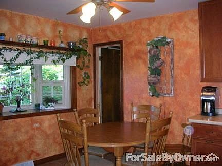 Kitchen with maple cabinets, all appliances and bay window.