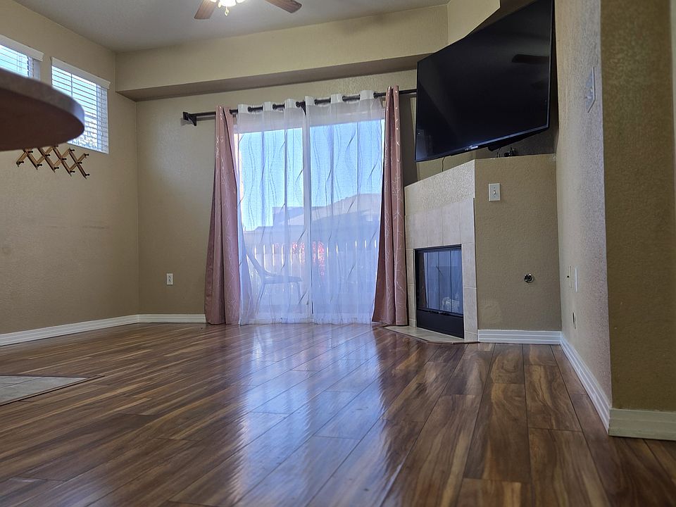 Living Room with a Gas Fireplace and a TV space for a large TV, and an additional storage room for storing large items like suitcases and gym equipment