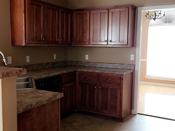 Kitchen with cherry wood cabinets.