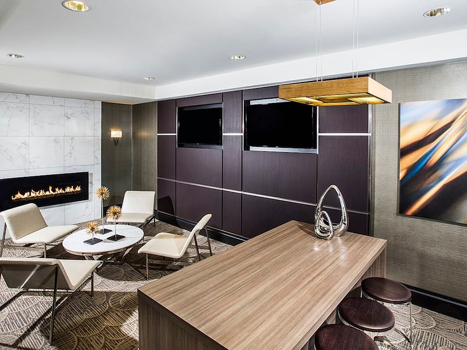 Social lounge with flat screen TVs and cozy fireplace.