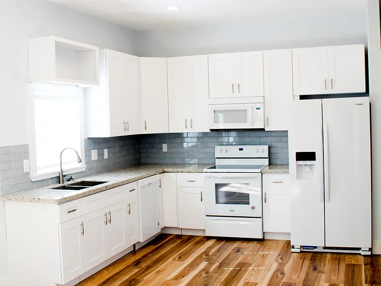 Kitchen features include garbage disposal, dishwasher, ice-maker on fridge door, large microwave with built-in hood and a window overlooking the gated courtyard.