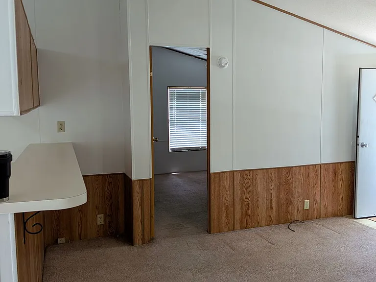 Living room view to primary bedroom, cathedral ceiling,