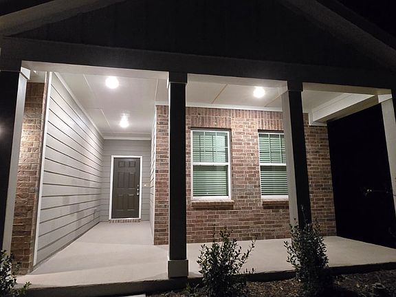 Front elevation at night with huge porch